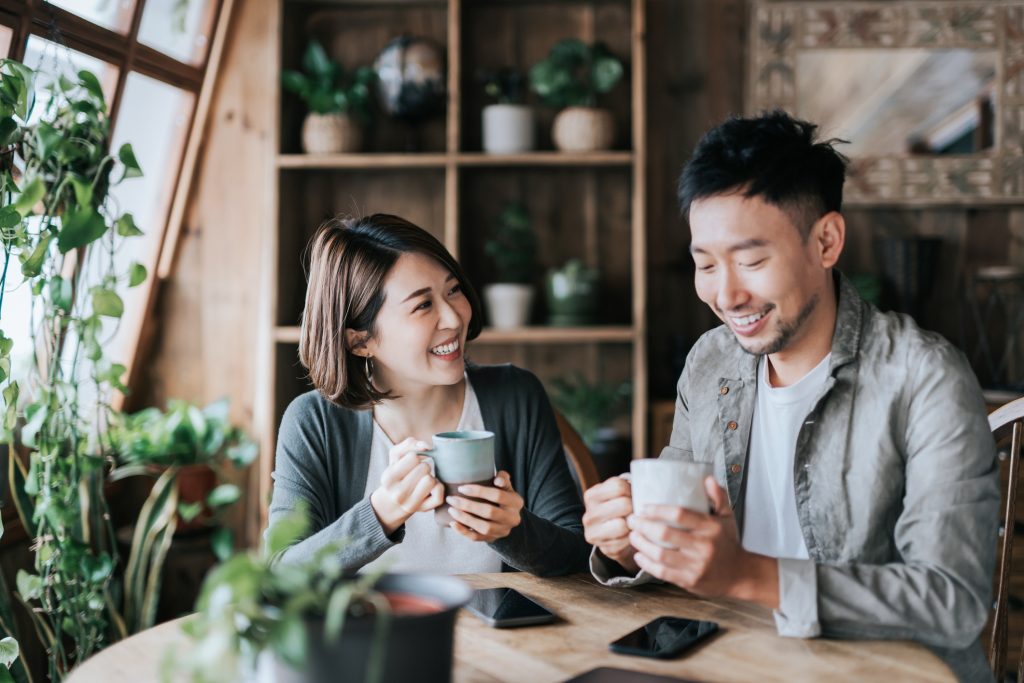 A couple drinking coffee happy that they are extending their lives and protecting their health.